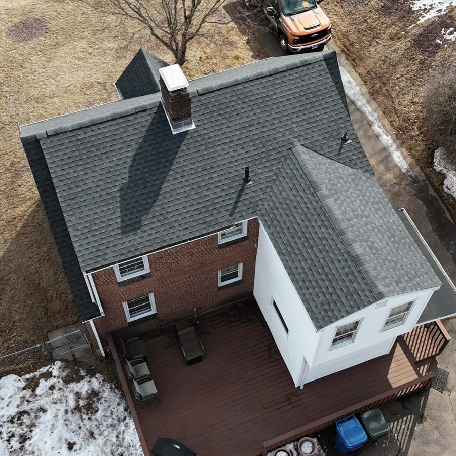 Brick home with a dark shingle roof