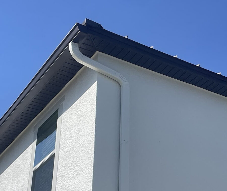 gutters Newly installed white gutters along a roofline