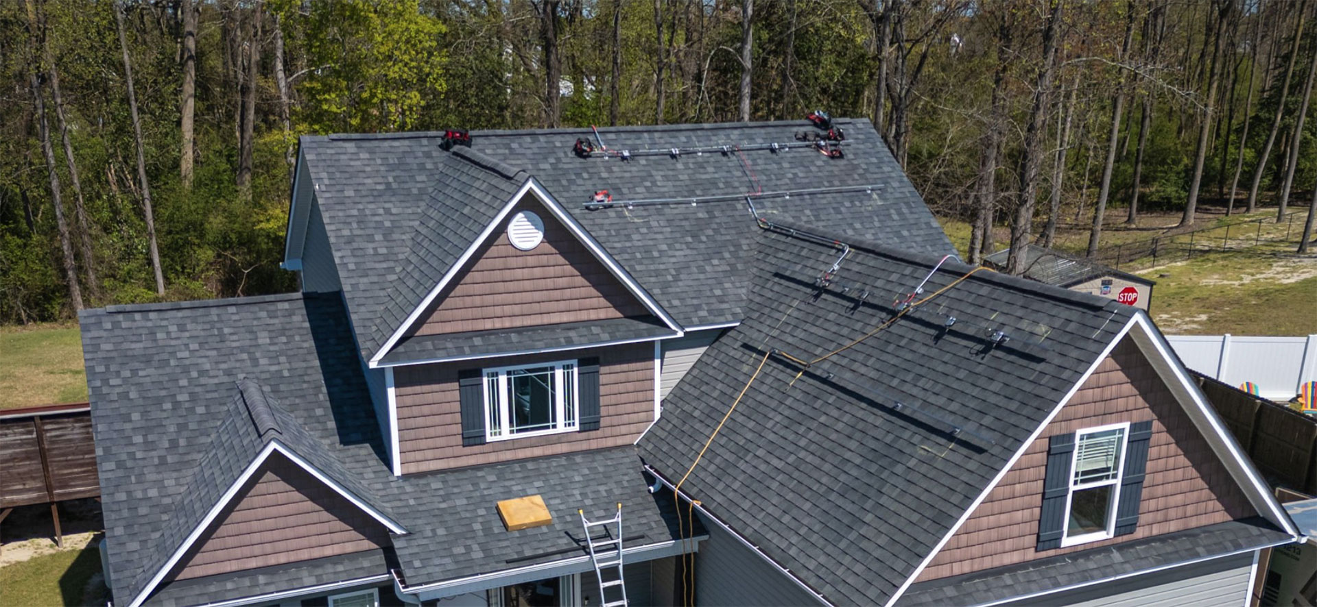 hero9 Home with a newly installed gray asphalt shingle roof