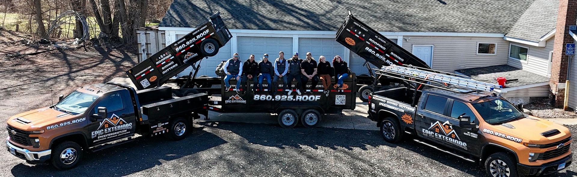 companypic Epic Exteriors team posing on a company flatbed truck