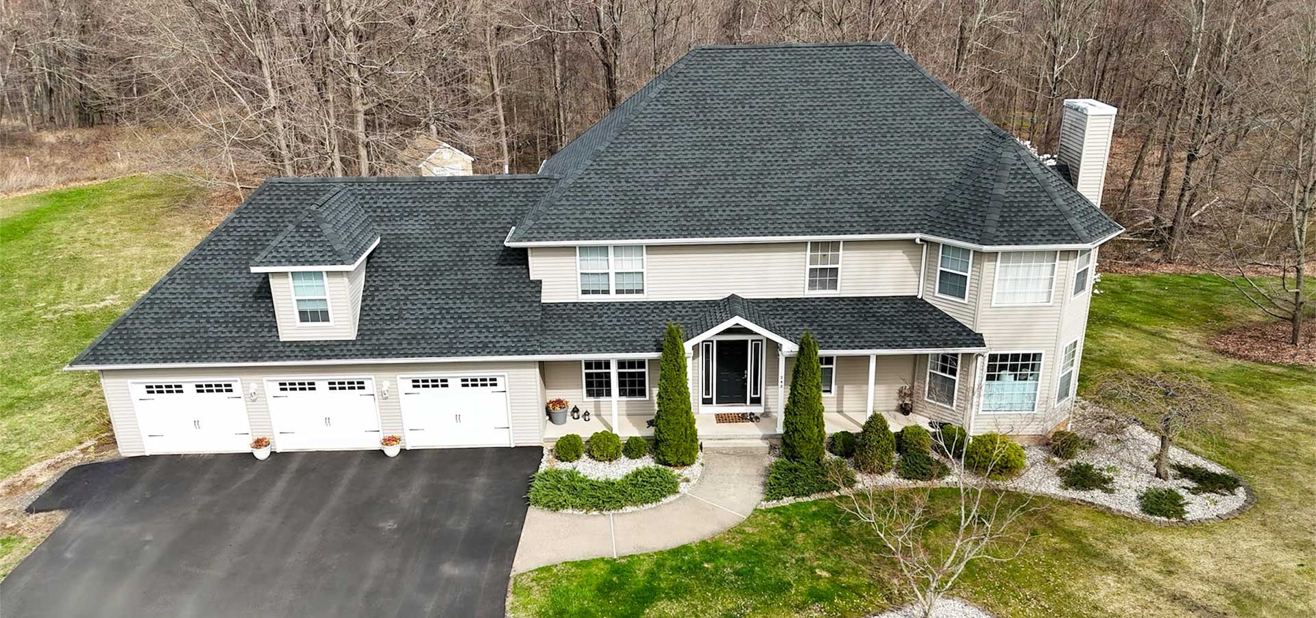 home-epic-img Aerial view of a two-story home with a gray shingle roof