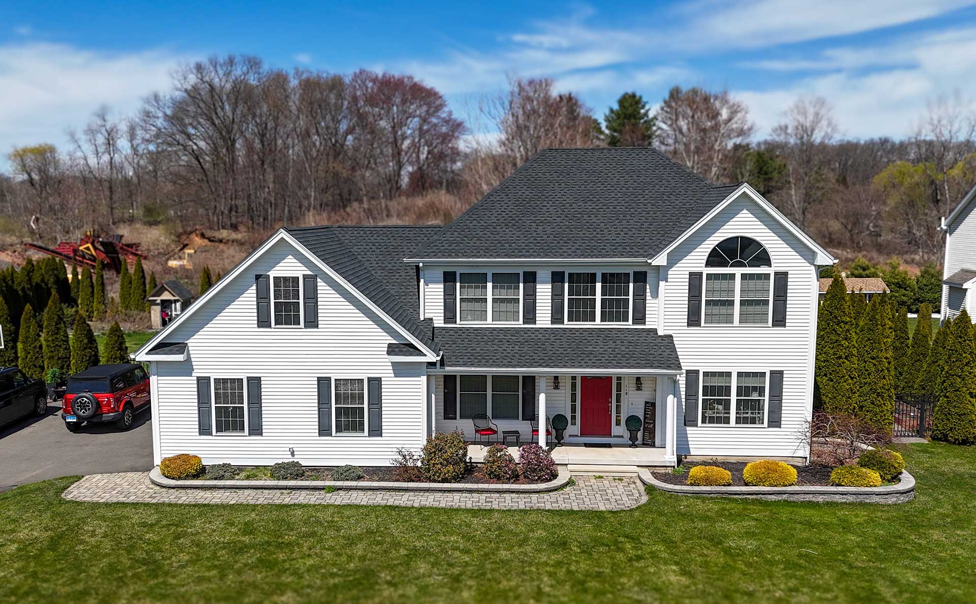 roofing-in-connecticut Aerial view of a two-story home with a gray shingle roof