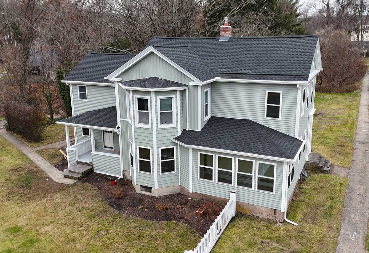 after-cheshire-roofing-remodel Aerial view of a home with a new gray shingle roof