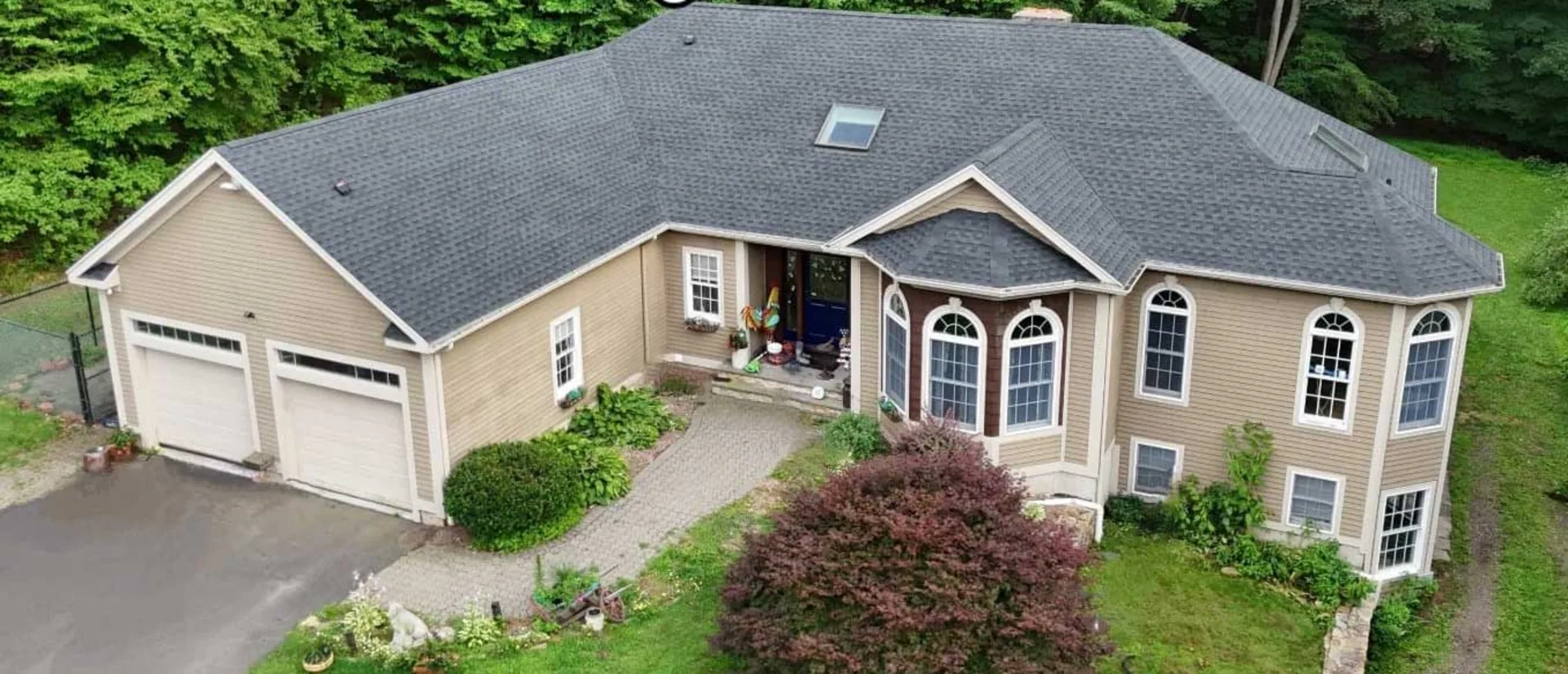 Skylight installation on a Connecticut home, aerial view Aerial view of a Connecticut home with a new skylight installed in its asphalt shingle roof by Epic Exteriors