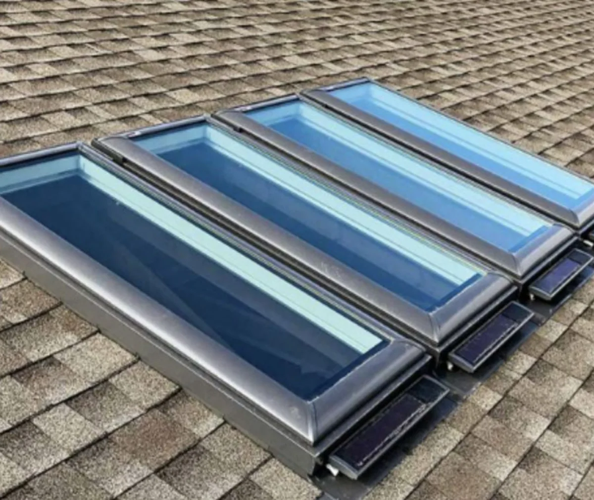 Three VELUX skylights installed on a shingle roof Three VELUX skylights installed side by side on an asphalt shingle roof in Southington, CT